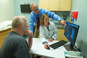 physician with patient looking at x ray