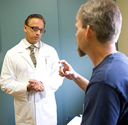 Physician explains to patient treatment options for a herniated disc